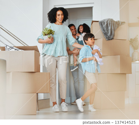 Kids, new home or parents moving boxes in real estate property investment or rental apartment. Mother helping, proud father or excited children carrying or walking by a box in family house together Kids, new home or parents moving boxes in real estate property investment or rental apartment. Mother helping, proud father or excited children carrying or walking by a box in family house together 137414525