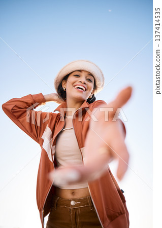 Portrait, woman smile and offer helping hand to welcome outdoor on low angle mockup space. Happy, palm and person giving assistance for support, care or acceptance of handshake sign for invitation 137414535