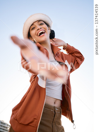 Excited woman, portrait and helping hand, offer and invitation outdoor in low angle. Funny, palm and person giving assistance for support, care and laughing in acceptance of handshake sign to welcome Excited woman, portrait and helping hand, offer and invitation outdoor in low angle. Funny, palm and person giving assistance for support, care and laughing in acceptance of handshake sign to welcome 137414539