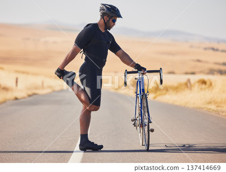 Man, cyclist and stretching on road with bicycle in fitness, training or outdoor sports in countryside. Active male person or athlete in body warm up, leg exercise or preparation in cycling or cardio Man, cyclist and stretching on road with bicycle in fitness, training or outdoor sports in countryside. Active male person or athlete in body warm up, leg exercise or preparation in cycling or cardio 137414669