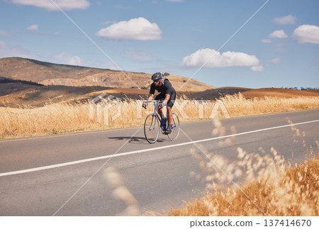 Fitness, nature and man cycling on road for workout, exercise and scenic mountain path. Health, wellness and cyclist on bike on summer morning for training, practice and bicycle race with blue sky. 137414670