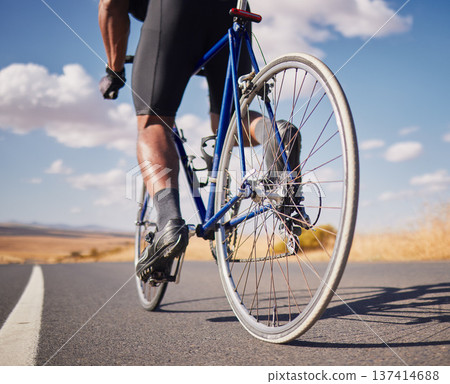 Road, closeup and man on a bike for cycling, race training or travel in the countryside. Health, exercise and legs of male cyclist or athlete with a bicycle for a workout, street cardio or triathlon 137414688