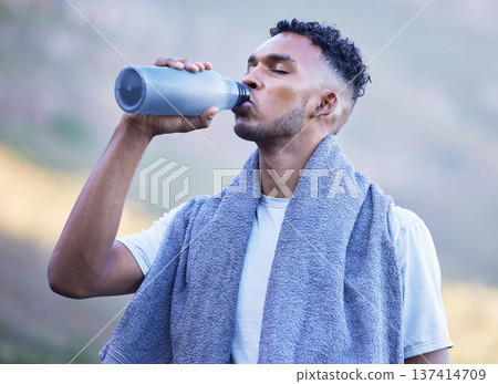 Fitness, exercise and a man drinking water outdoor on a break or rest after run, workout or training. Tired athlete person or runner in nature with a bottle for thirst, cardio or health and wellness Fitness, exercise and a man drinking water outdoor on a break or rest after run, workout or training. Tired athlete person or runner in nature with a bottle for thirst, cardio or health and wellness 137414709