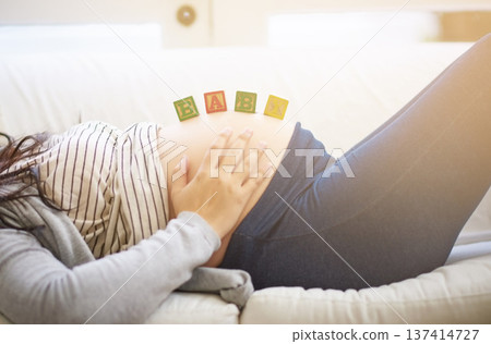Home, pregnant woman and hands with building blocks, baby announcement or prenatal belly support. Pregnancy news, rest or person with wooden toys on stomach, future parenthood or coming soon message Home, pregnant woman and hands with building blocks, baby announcement or prenatal belly support. Pregnancy news, rest or person with wooden toys on stomach, future parenthood or coming soon message 137414727
