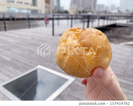 A close-up of a fluffy custard cream puff. A close-up of a fluffy custard cream puff. 137414762