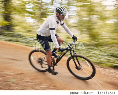 Blurred speed, cycling and man in nature training for a race, marathon or competition in a forest. Fast, fitness and male cyclist athlete riding bicycle for cardio exercise or workout on a mountain. 137414783