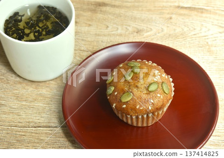 butter banana cake topping peanut and whole grain on plate with hot Chinese tea cup butter banana cake topping peanut and whole grain on plate with hot Chinese tea cup 137414825