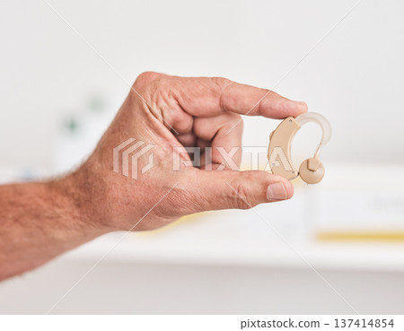 Hearing aid, hands and person with disability for medical support, healthcare innovation and volume. Closeup of deaf patient with audiology implant to help sound waves, amplifier or improve listening 137414854