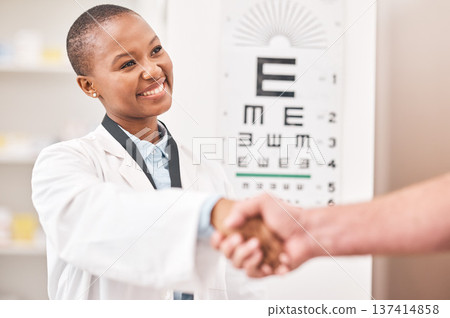 Optometrist woman, handshake and smile with patient, customer and happy for agreement, deal or sale. African ophthalmology doctor, shaking hands and kindness for healthy eyes, wellness or healthcare Optometrist woman, handshake and smile with patient, customer and happy for agreement, deal or sale. African ophthalmology doctor, shaking hands and kindness for healthy eyes, wellness or healthcare 137414858
