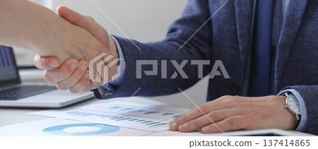 Business partners shaking hands at meeting after signing contract, finishing up collaboration or making successful deal. Business people concept Business partners shaking hands at meeting after signing contract, finishing up collaboration or making successful deal. Business people concept 137414865