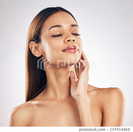 Woman, touching face and natural beauty in a studio, wellness and dermatology isolated on white background. Anti aging, treatment and skincare with glow, makeup and healthy skin with cosmetics shine Woman, touching face and natural beauty in a studio, wellness and dermatology isolated on white background. Anti aging, treatment and skincare with glow, makeup and healthy skin with cosmetics shine 137414868