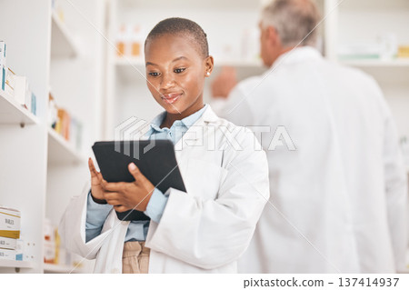 Inventory, pharmacist and black woman with a tablet, healthcare and research with connection in a drugstore. Medical, pharmaceutical and African person with technology, network or check prescription Inventory, pharmacist and black woman with a tablet, healthcare and research with connection in a drugstore. Medical, pharmaceutical and African person with technology, network or check prescription 137414937