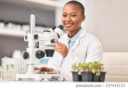 Science portrait, woman and plants, microscope or laboratory research for agriculture, sustainability and leaves test. Scientist, African student or happy doctor, lens and eco study or food security Science portrait, woman and plants, microscope or laboratory research for agriculture, sustainability and leaves test. Scientist, African student or happy doctor, lens and eco study or food security 137415113