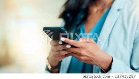 Closeup of a woman texting, browsing and scrolling on a phone in an office. Hands of a corporate executive, busy entrepreneur and business expert typing a message while networking with clients online Closeup of a woman texting, browsing and scrolling on a phone in an office. Hands of a corporate executive, busy entrepreneur and business expert typing a message while networking with clients online 137415287