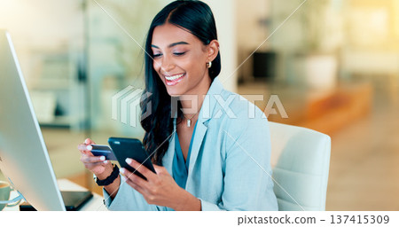 Happy woman making online payment with phone and bank card for typing credit details into online banking app. Young business woman enjoying virtual shopping or wireless purchase while sitting inside Happy woman making online payment with phone and bank card for typing credit details into online banking app. Young business woman enjoying virtual shopping or wireless purchase while sitting inside 137415309