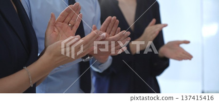 Business people applauding, showing appreciation and support, celebrating success and achievement during a corporate meeting or event at the office Business people applauding, showing appreciation and support, celebrating success and achievement during a corporate meeting or event at the office 137415416