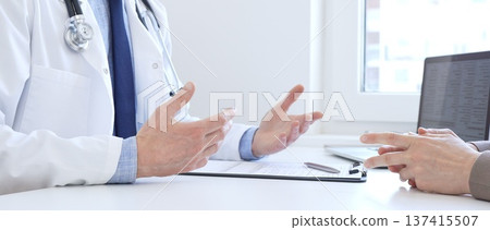Doctor gesturing with hands while explaining diagnosis to patient during medical consultation in hospital office, healthcare and medical concept. Medicine Doctor gesturing with hands while explaining diagnosis to patient during medical consultation in hospital office, healthcare and medical concept. Medicine 137415507