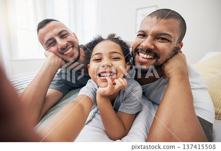Gay, family and selfie portrait of child in home bedroom, bonding and fun together. Face of men, lgbtq parents and girl on bed in adoption, foster and profile picture, happy memory and interracial 137415508