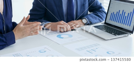 Business people reviewing financial data, discussing and shared documents during collaborative strategy session. Audit and finance concept 137415580
