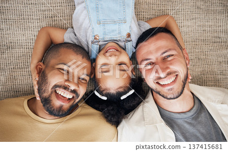 Gay dad, blended family and foster with a girl lying together on the floor of the home for adoption from above. LGBT love, children or kids and a daughter bonding with her happy parents in the house Gay dad, blended family and foster with a girl lying together on the floor of the home for adoption from above. LGBT love, children or kids and a daughter bonding with her happy parents in the house 137415681