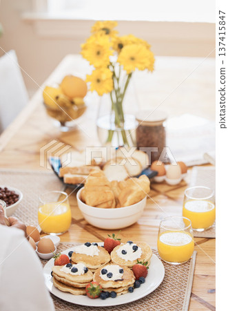Pancakes, breakfast and orange juice on table in home in the morning. Bread waffle, hands and fruits for eating, healthy diet and strawberry cream in wellness nutrition, blueberry food and egg meal. Pancakes, breakfast and orange juice on table in home in the morning. Bread waffle, hands and fruits for eating, healthy diet and strawberry cream in wellness nutrition, blueberry food and egg meal. 137415847