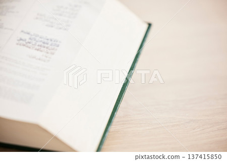 Islam, table and closeup of a Quran for reading, support and hope from a book in a house. Closeup, desk and an Arabic or Muslim teaching for prayer, spiritual faith or education from holy scripture Islam, table and closeup of a Quran for reading, support and hope from a book in a house. Closeup, desk and an Arabic or Muslim teaching for prayer, spiritual faith or education from holy scripture 137415850