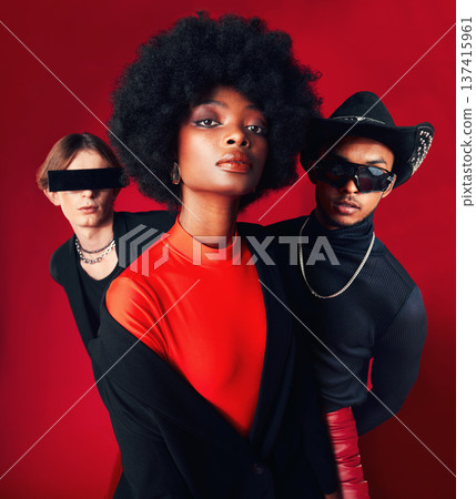 Fashion, portrait and a group of people, style and retro clothes on a red studio background for art, punk and creative aesthetic. Friends, rock or a black woman with men with vintage or trendy outfit Fashion, portrait and a group of people, style and retro clothes on a red studio background for art, punk and creative aesthetic. Friends, rock or a black woman with men with vintage or trendy outfit 137415961