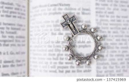 Rosary, open book or bible study for worship, religion or mindfulness with holy spiritual scripture. Christian literature, background or history education or knowkedge guide on God or Jesus Christ 137415969