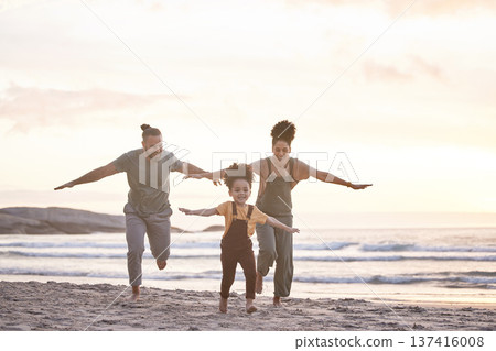 Travel, freedom and a family at the beach during sunset for flying, playing and bonding at the ocean. Smile, holiday and an interracial child, mother and father at the sea for a vacation or summer Travel, freedom and a family at the beach during sunset for flying, playing and bonding at the ocean. Smile, holiday and an interracial child, mother and father at the sea for a vacation or summer 137416008
