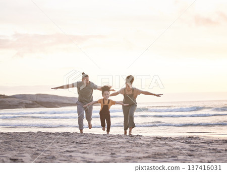 Happy, freedom and a family at the beach during sunset for flying, playing and bonding at the ocean. Smile, carefree and an interracial child, mother and father at the sea for a vacation or summer Happy, freedom and a family at the beach during sunset for flying, playing and bonding at the ocean. Smile, carefree and an interracial child, mother and father at the sea for a vacation or summer 137416031