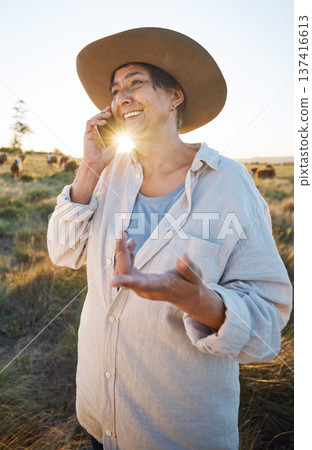 Woman, farmer and phone call in morning, countryside and person on farm with smile for live stock in nature with connection. Happy, female worker and social network, communication and contact 137416613