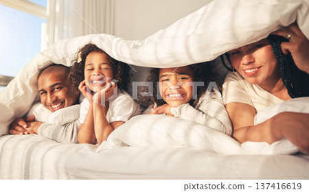 Happy family, bed and under blanket in home bedroom while comfortable, portrait and together. African woman, man and kids lying with cover for security, wake up and relax with mother and father Happy family, bed and under blanket in home bedroom while comfortable, portrait and together. African woman, man and kids lying with cover for security, wake up and relax with mother and father 137416619