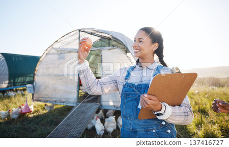 Agriculture, farm and a woman with an egg for inspection and a clipboard for quality control. Farming, sustainability and a poultry farmer person with organic produce outdoor for growth or production Agriculture, farm and a woman with an egg for inspection and a clipboard for quality control. Farming, sustainability and a poultry farmer person with organic produce outdoor for growth or production 137416727