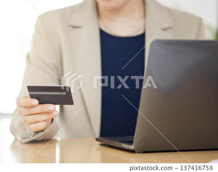 Online shopping, credit card and business woman with payment on a internet or banking on a laptop. Hands, loan and corporate professional or customer use rewards to purchase on ecommerce website 137416758