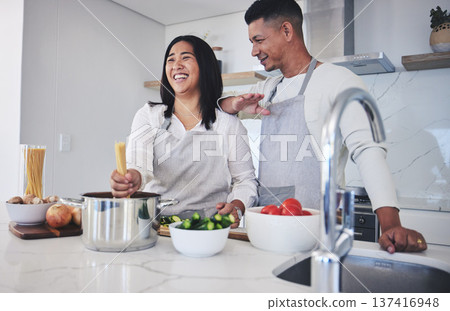 Laughing, cooking and love with couple in kitchen for food, health and lunch recipe. Happy, nutrition and dinner with man and woman and pasta at home for diet, wellness and romance together 137416948