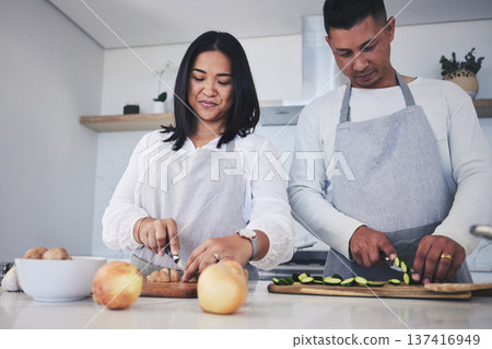 Help, cooking and love with couple in kitchen for food, health and lunch recipe. Happy, nutrition and dinner with man and woman cutting vegetables at home for diet, wellness and romance together 137416949