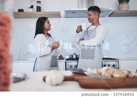 Couple in kitchen, coffee and cooking together with conversation, smile and love in home. Relax, man and woman in bonding discussion, making food for dinner vegetables and drinking tea in apartment. Couple in kitchen, coffee and cooking together with conversation, smile and love in home. Relax, man and woman in bonding discussion, making food for dinner vegetables and drinking tea in apartment. 137416950