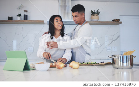 Tablet, cooking and couple in a kitchen, recipe and bonding with love, marriage and conversation. Home, man and woman with technology, online reading and nutrition with instructions and prepare lunch Tablet, cooking and couple in a kitchen, recipe and bonding with love, marriage and conversation. Home, man and woman with technology, online reading and nutrition with instructions and prepare lunch 137416970