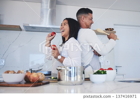 Happy couple, food and fun cooking in kitchen together for healthy eating or natural nutrition at home. Man and woman enjoying teamwork or bonding in happiness for breakfast, lunch or supper meal 137416971