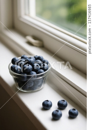 Fresh blueberries in a glass bowl by the window Fresh blueberries in a glass bowl by the window 137416985