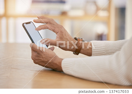 Hands, phone and social media with a person in their home dining room for communication as an app user. Mobile, contact and email with an adult in a house closeup for networking or browsing the web Hands, phone and social media with a person in their home dining room for communication as an app user. Mobile, contact and email with an adult in a house closeup for networking or browsing the web 137417033