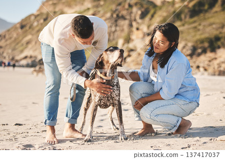 Beach, happy and couple with dog by ocean for freedom, adventure and bonding together in nature. Happy pet, domestic animal and man and woman play by sea for exercise, wellness and walking in nature 137417037