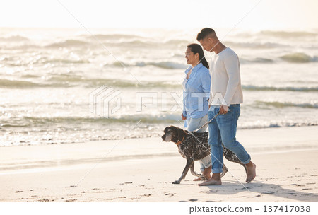 Beach, pet and couple walking with dog by ocean for freedom, adventure and bonding together in nature. Healthy animal, dating and man and woman by sea for exercise, wellness and training at sunset Beach, pet and couple walking with dog by ocean for freedom, adventure and bonding together in nature. Healthy animal, dating and man and woman by sea for exercise, wellness and training at sunset 137417038