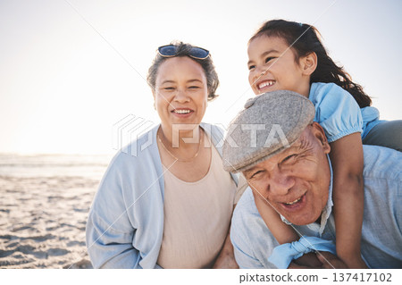 Fun, beach and girl playing with her grandparents on a family vacation, adventure or holiday. Happy, smile and child on a piggyback ride and bonding with her grandmother and grandfather by the ocean. Fun, beach and girl playing with her grandparents on a family vacation, adventure or holiday. Happy, smile and child on a piggyback ride and bonding with her grandmother and grandfather by the ocean. 137417102