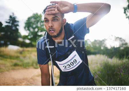 Runner man, race and tired in nature, thinking and rest for sweat, breathe or vision in woods for triathlon. Athlete guy, face and idea for strategy, fatigue or burnout in forest, marathon or hiking] 137417160