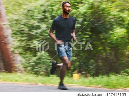 Man running with speed in park for exercise, fitness and power of cardio workout, action and race. Runner, sports athlete and motion blur for marathon training, energy and fast performance outdoor Man running with speed in park for exercise, fitness and power of cardio workout, action and race. Runner, sports athlete and motion blur for marathon training, energy and fast performance outdoor 137417165