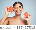 Happy, woman and grapefruit skincare in studio for natural, cosmetic and wellness on grey background. Face, smile and model with citrus, fruit and organic treatment for anti aging, glow or vitamin c 137417518