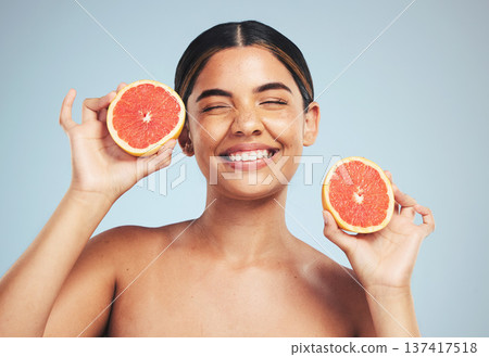 Happy, woman and grapefruit skincare in studio for natural, cosmetic and wellness on grey background. Face, smile and model with citrus, fruit and organic treatment for anti aging, glow or vitamin c Happy, woman and grapefruit skincare in studio for natural, cosmetic and wellness on grey background. Face, smile and model with citrus, fruit and organic treatment for anti aging, glow or vitamin c 137417518