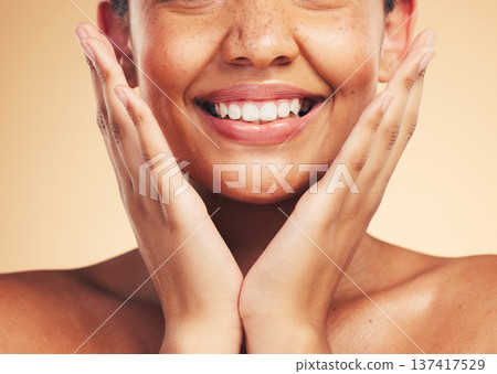 Skincare, smile and hands on woman face in studio for cosmetic, wellness and dermatology on brown background. Happy, beauty and lady model excited for glowing skin, results or self love cosmetology 137417529