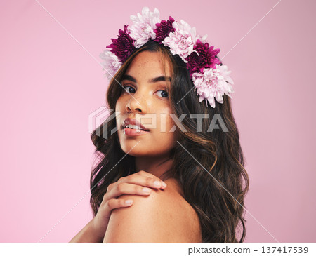 Woman, flower crown and portrait in studio for beauty, natural skincare and spring plants on pink background. Face, model and floral wreath for sustainability, eco dermatology and hair care cosmetics Woman, flower crown and portrait in studio for beauty, natural skincare and spring plants on pink background. Face, model and floral wreath for sustainability, eco dermatology and hair care cosmetics 137417539
